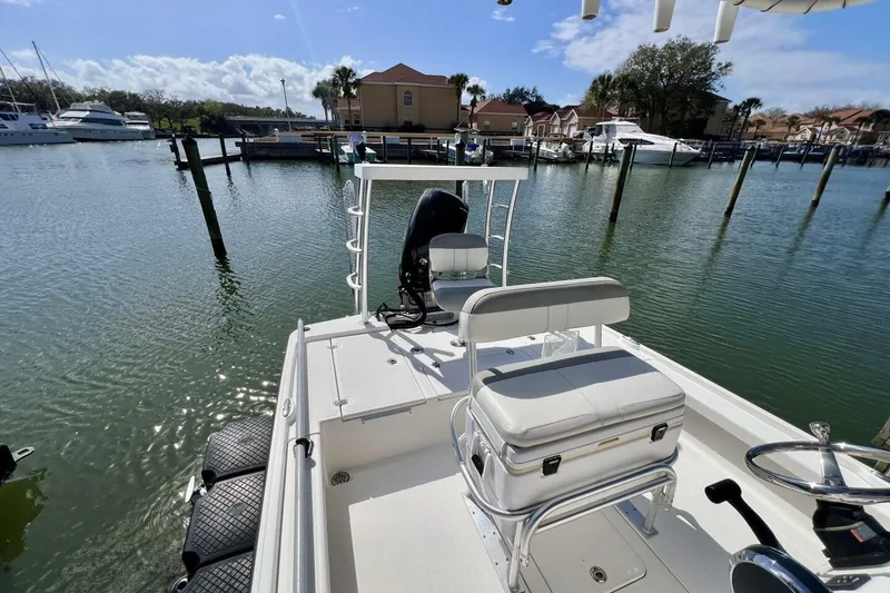 Slide: The Image of 2021 Mako 21 LTS boat docked at marina, sunny day, calm water. - 44