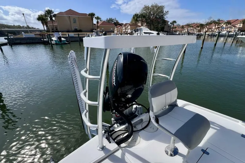 Slide: The Image of 2021 Mako 21 LTS boat with Mercury engine docked in a marina. - 49