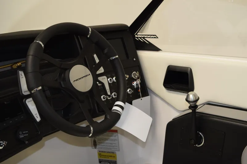 Slide: The Image of 2026 Moomba Craz boat dashboard with steering wheel and control panel. - 10