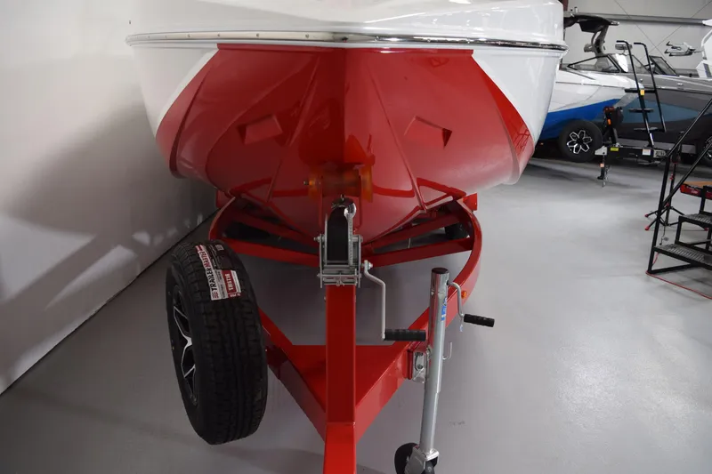 Slide: The Image of 2026 Moomba Craz boat on red trailer in showroom, front view. - 22