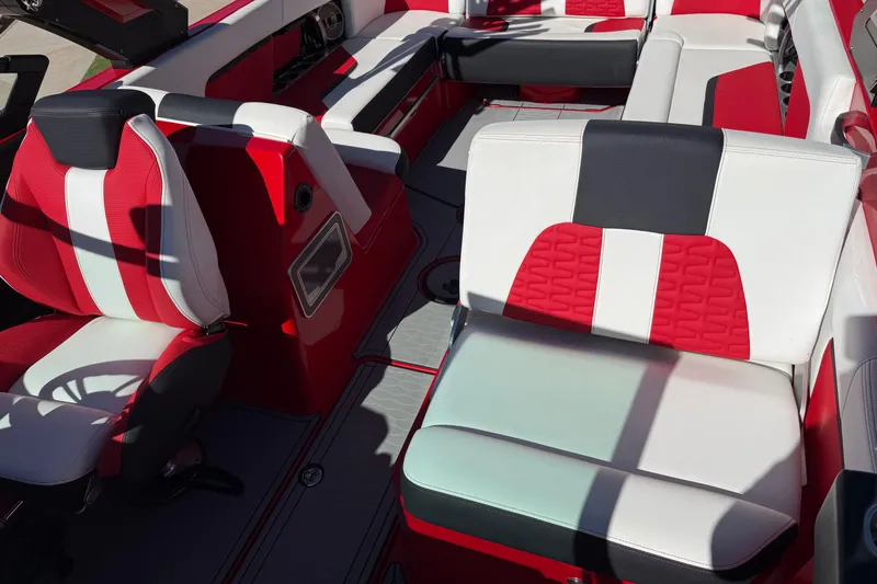 Slide: The Image of 2022 MasterCraft X26 boat interior with red and white seating design. - 10