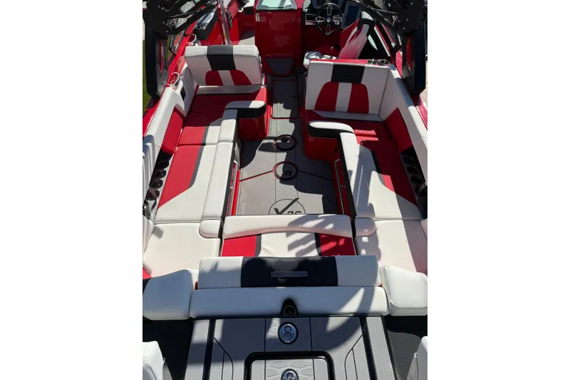 Slide: The Image of 2022 MasterCraft X26 boat interior with red and white seating, showcasing luxury design. - 16