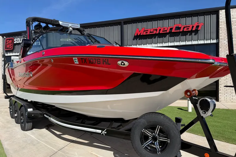 Slide: The Image of 2022 MasterCraft X26 boat in vibrant red, displayed outside dealership. - 4