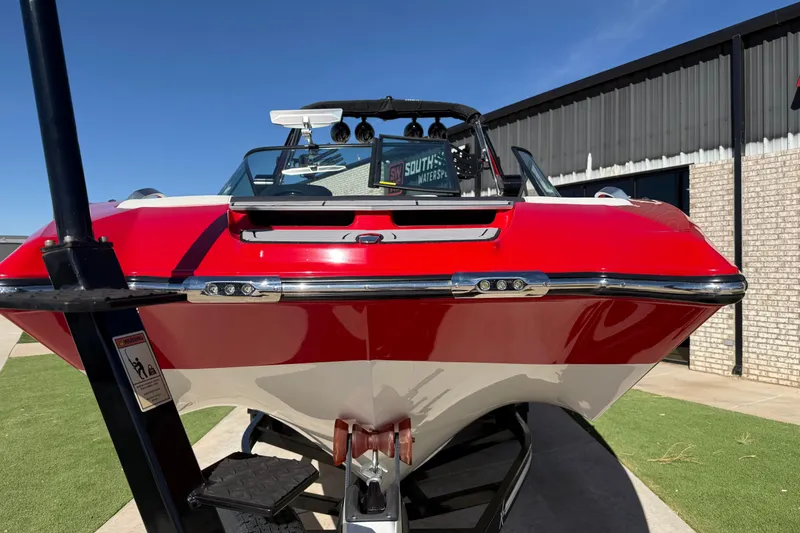 Slide: The Image of 2022 MasterCraft X26 boat with red and white exterior, displayed outdoors. - 5