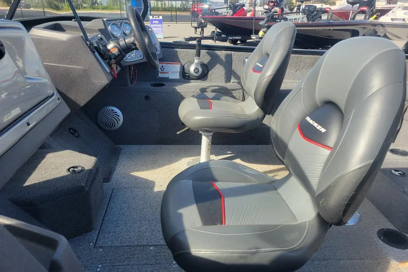 Slide: The Image of 2022 Tracker Pro Guide V-175 Combo boat interior with steering wheel and seating. - 10