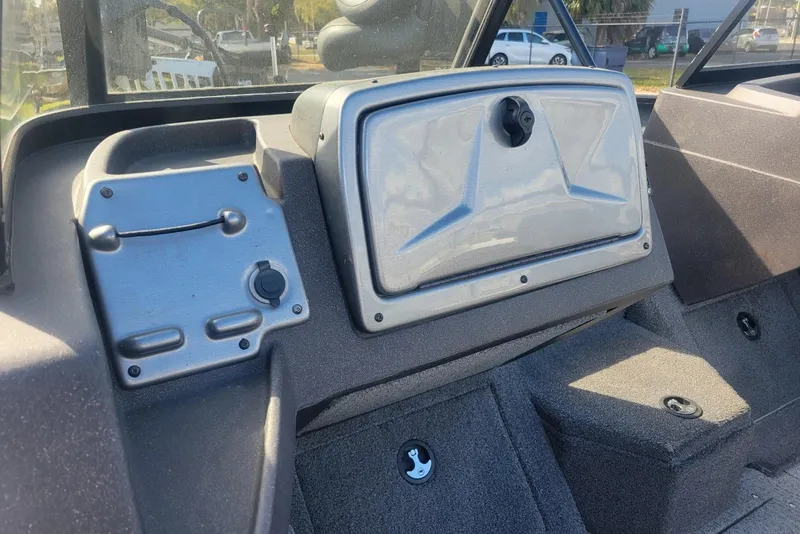 Slide: The Image of 2022 Tracker Pro Guide V-175 Combo boat dashboard with storage compartment and controls. - 11