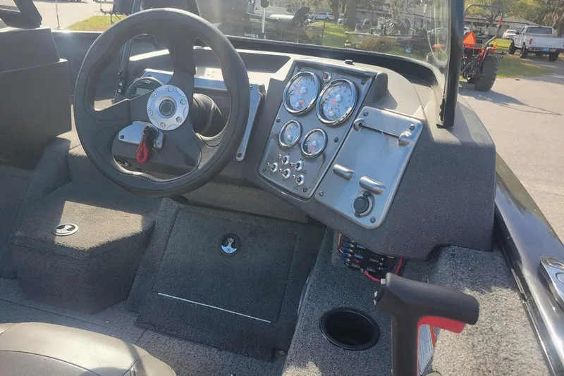 Slide: The Image of 2022 Tracker Pro Guide V-175 Combo boat dashboard with steering wheel and instrument panel. - 12