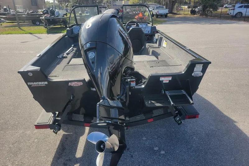 Slide: The Image of 2022 Tracker Pro Guide V-175 Combo boat with powerful outboard motor, parked outdoors. - 4