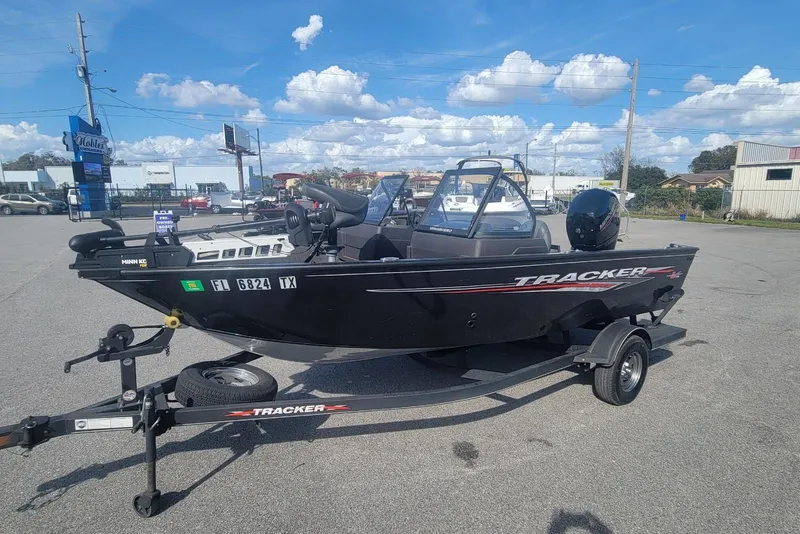 Slide: The Image of 2022 Tracker Pro Guide V-175 Combo boat on trailer in parking lot. - 7