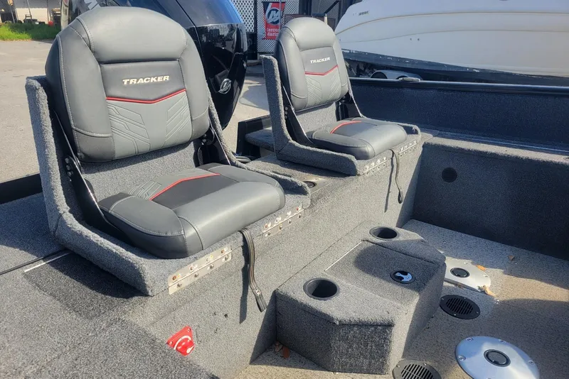 Slide: The Image of 2022 Tracker Pro Guide V-175 Combo boat interior with two gray seats and cup holders. - 9