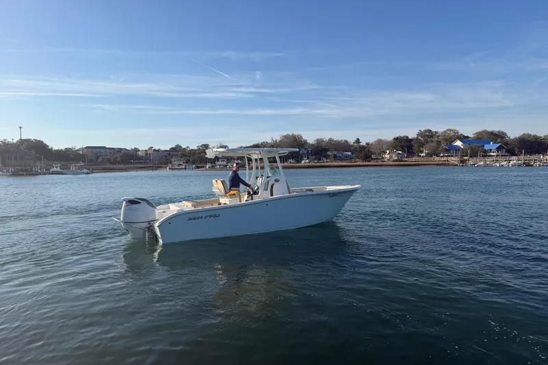 Slide: The Image of 2023 Sea Pro 239 Center Console boat cruising on a calm waterway. - 12