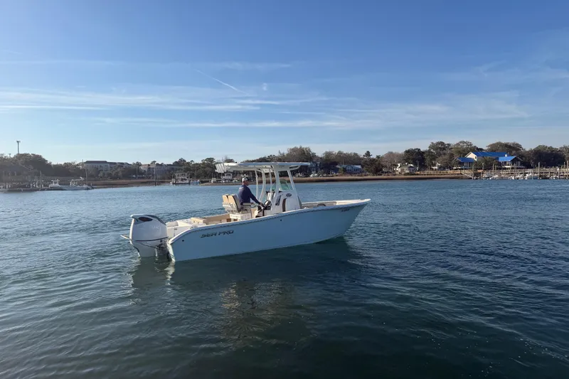 Slide: The Image of 2023 Sea Pro 239 Center Console boat cruising on a calm waterway. - 13