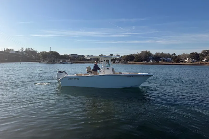 Slide: The Image of 2023 Sea Pro 239 Center Console boat cruising on a calm waterway. - 14