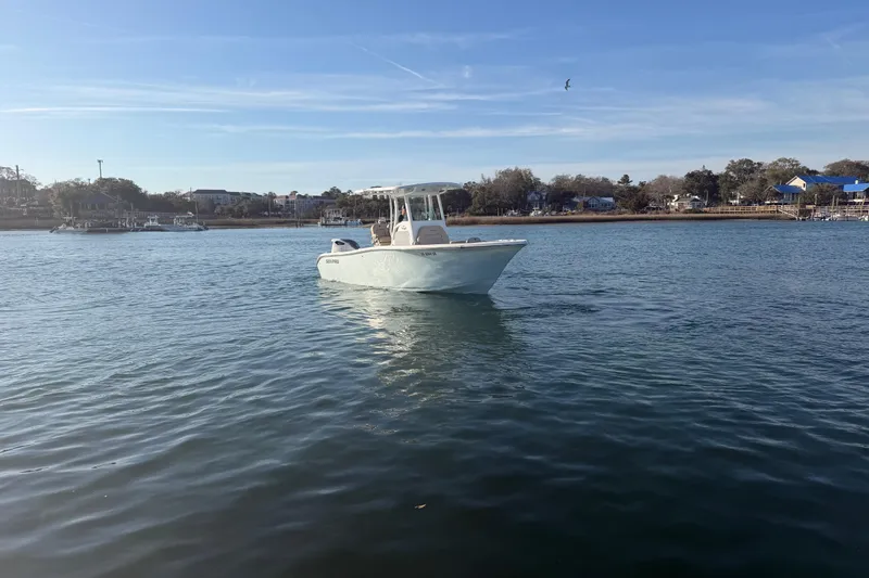 Slide: The Image of 2023 Sea Pro 239 Center Console boat on calm water near shoreline. - 15