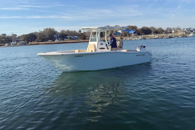 Slide: The Image of 2023 Sea Pro 239 Center Console boat on calm water, scenic shoreline background. - 20