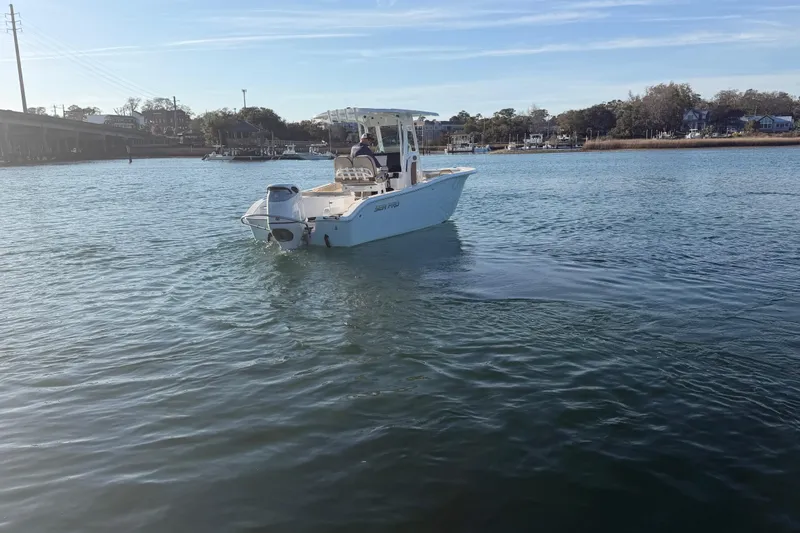 Slide: The Image of 2023 Sea Pro 239 Center Console boat cruising on a calm waterway. - 23