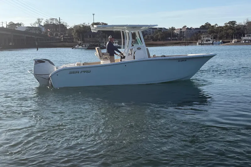 Slide: The Image of 2023 Sea Pro 239 Center Console boat on calm water, side view. - 25