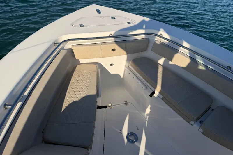 Slide: The Image of 2023 Sea Pro 239 Center Console boat interior with cushioned seating, on calm water. - 29