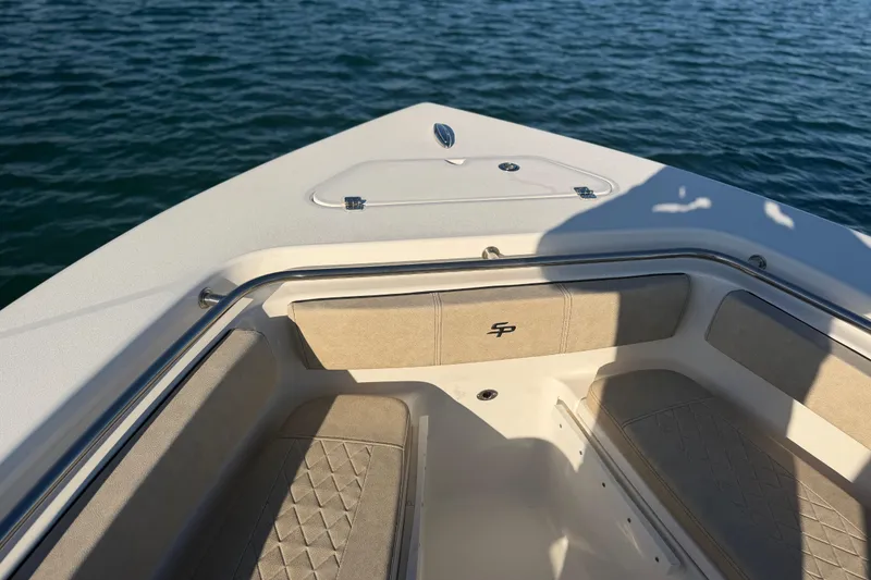Slide: The Image of 2023 Sea Pro 239 Center Console boat interior with cushioned seating on calm water. - 31