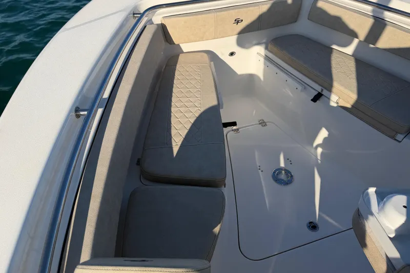 Slide: The Image of 2023 Sea Pro 239 Center Console boat interior with cushioned seating and storage. - 36