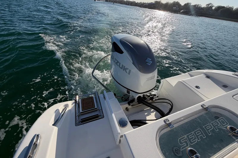 Slide: The Image of 2023 Sea Pro 239 Center Console boat with Suzuki engine on open water. - 45