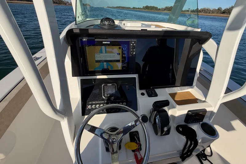 Slide: The Image of 2023 Sea Pro 239 Center Console boat dashboard with navigation system and steering wheel. - 48