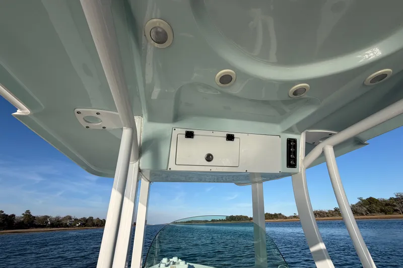 Slide: The Image of 2023 Sea Pro 239 Center Console boat interior with overhead console and ocean view. - 49