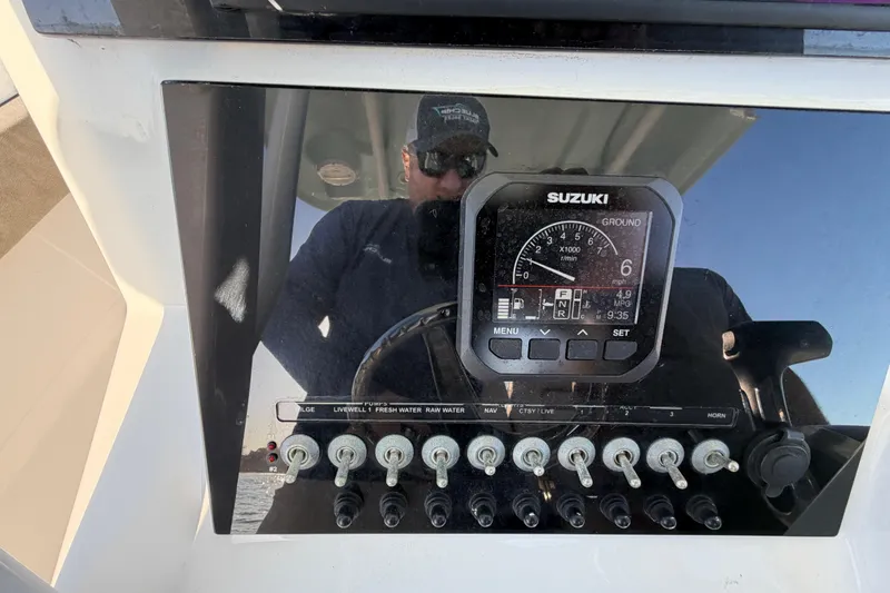 Slide: The Image of Console of 2023 Sea Pro 239 Center Console boat with Suzuki display and switches. - 51