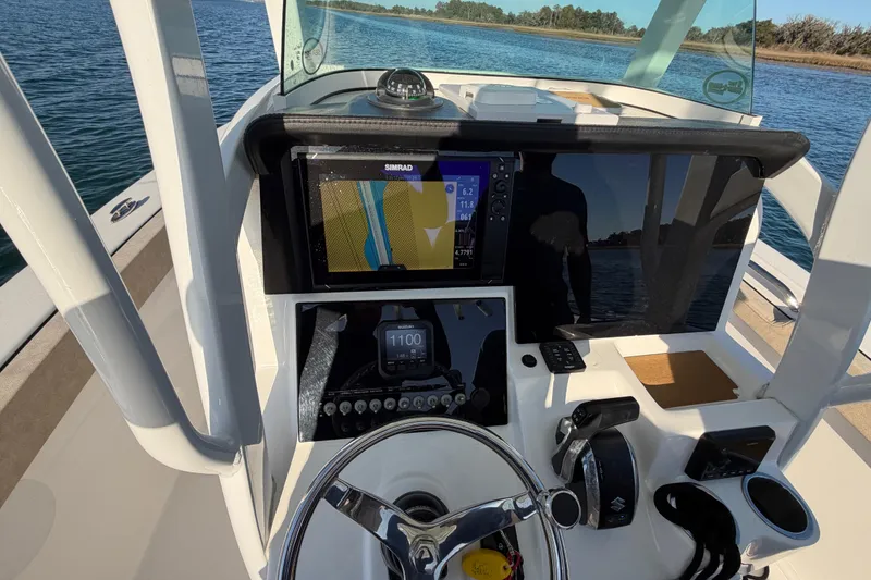 Slide: The Image of 2023 Sea Pro 239 Center Console boat dashboard with navigation system on a sunny day. - 52