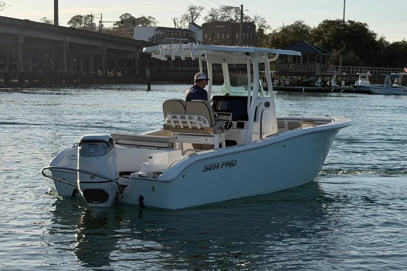 Slide: The Image of 2023 Sea Pro 239 Center Console boat on water near a bridge. - 7