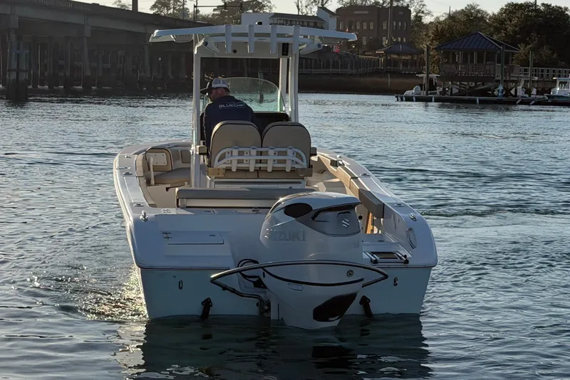 Slide: The Image of 2023 Sea Pro 239 Center Console boat on water, rear view with Suzuki outboard motor. - 8