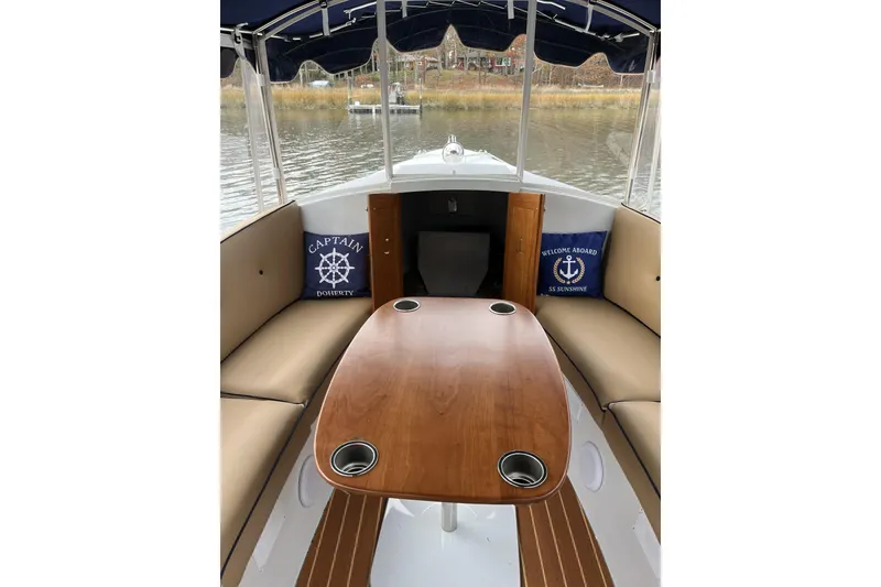 Slide: The Image of 2021 Duffy Cuddy Cabin 22 interior with wooden table and cushioned seating. - 8