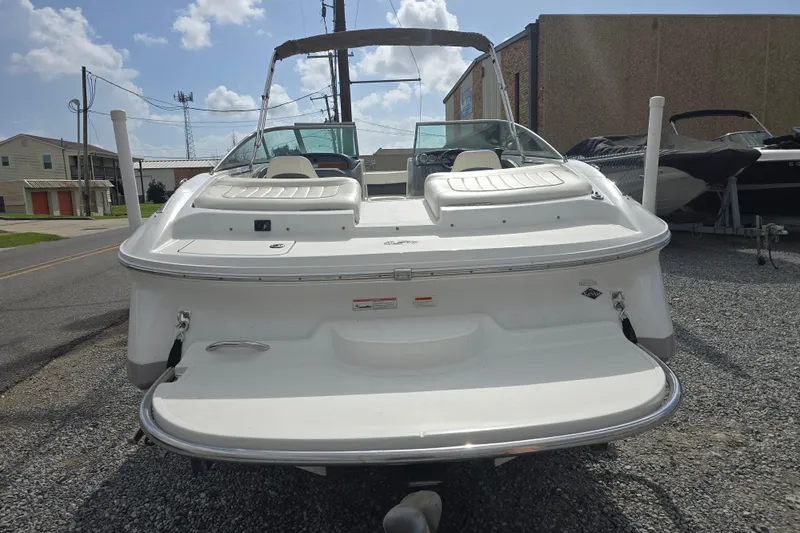 Slide: The Image of 2007 Cobalt 212 boat, rear view, parked on gravel, under a clear sky. - 2