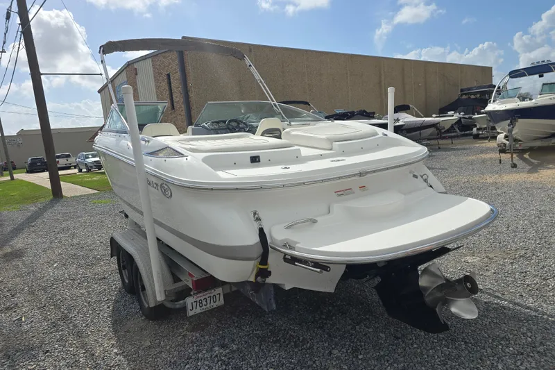 Slide: The Image of 2007 Cobalt 212 boat on trailer, parked outdoors under a clear sky. - 3