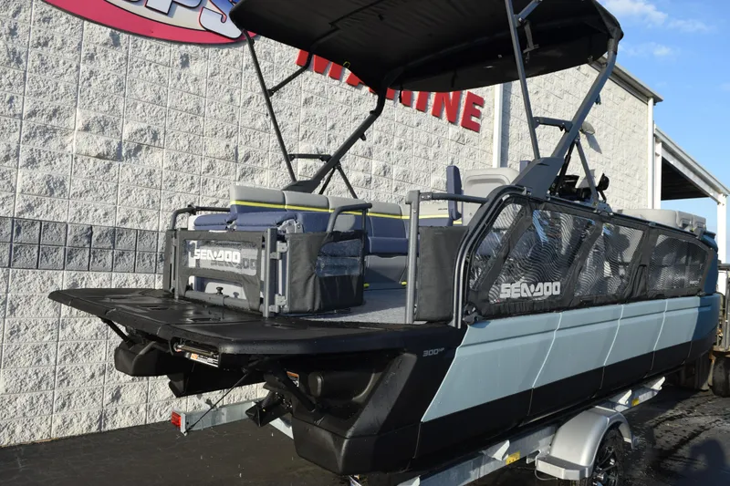 Slide: The Image of 2026 Sea-Doo Switch Cruise Limited 21 pontoon boat displayed outdoors. - 4