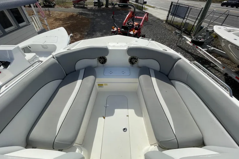 Slide: The Image of 2022 NauticStar 223 DC boat interior with gray seating and speakers. - 3