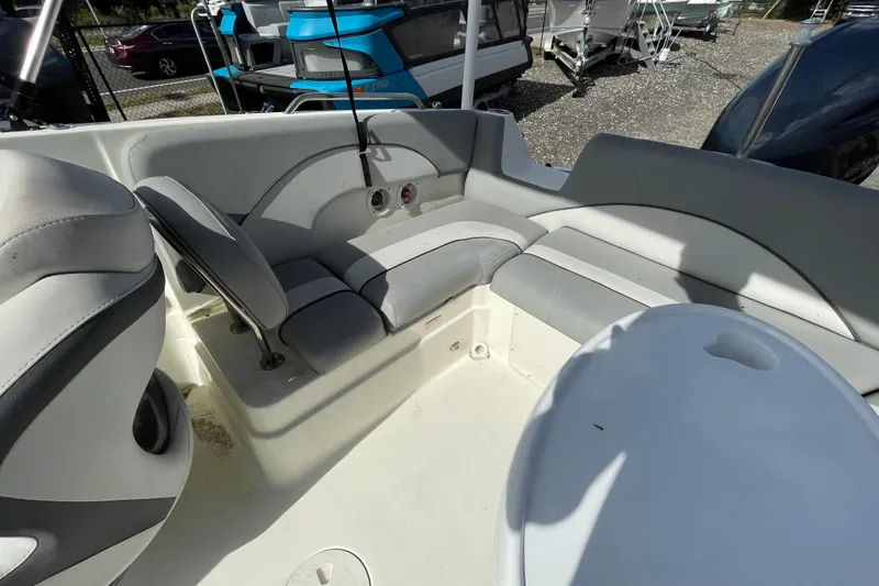 Slide: The Image of 2022 NauticStar 223 DC boat interior with gray seating and white table. - 6