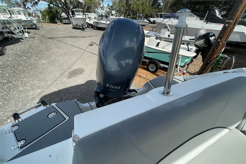 Slide: The Image of 2022 NauticStar 223 DC boat with Yamaha 150 engine in a marina setting. - 8