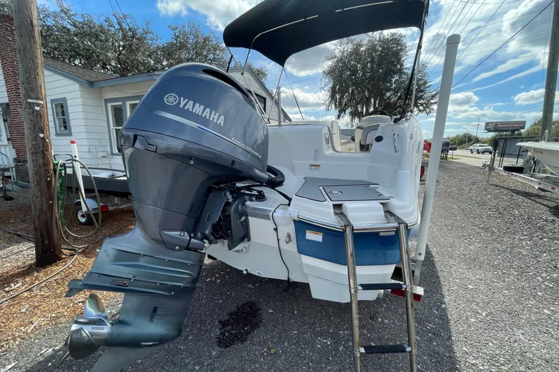 Slide: The Image of 2022 NauticStar 223 DC boat with Yamaha outboard motor, parked outdoors. - 9