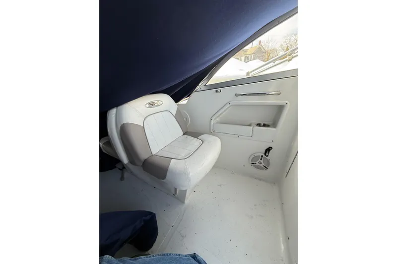 Slide: The Image of Interior of a 2011 Sea Hunt Escape 220 LE boat, featuring a cushioned seat. - 11