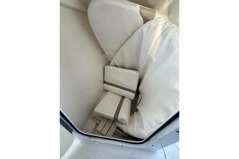 Slide: The Image of Cushioned seating inside 2011 Sea Hunt Escape 220 LE boat cabin. - 13