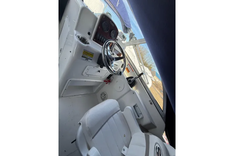 Slide: The Image of 2011 Sea Hunt Escape 220 LE boat interior with steering wheel and dashboard. - 14