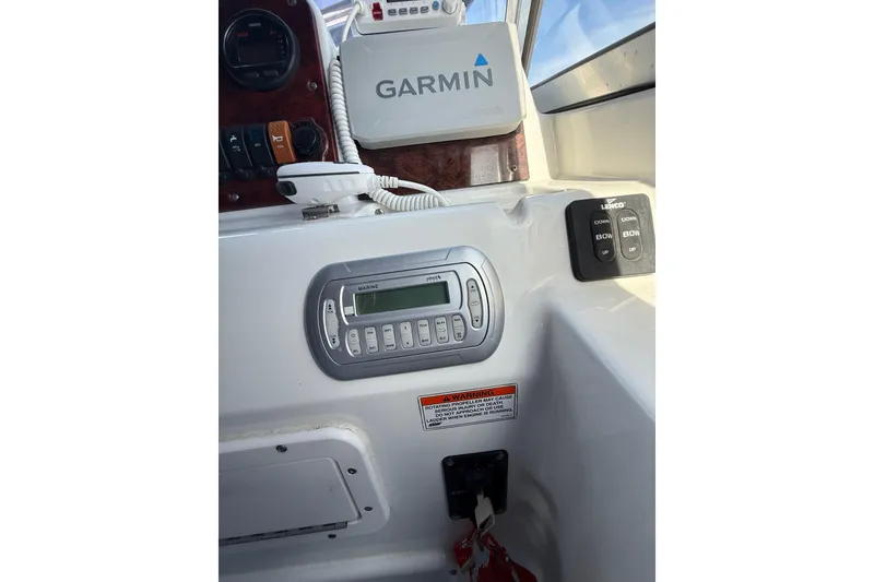 Slide: The Image of 2011 Sea Hunt Escape 220 LE dashboard with Garmin GPS and marine controls. - 16