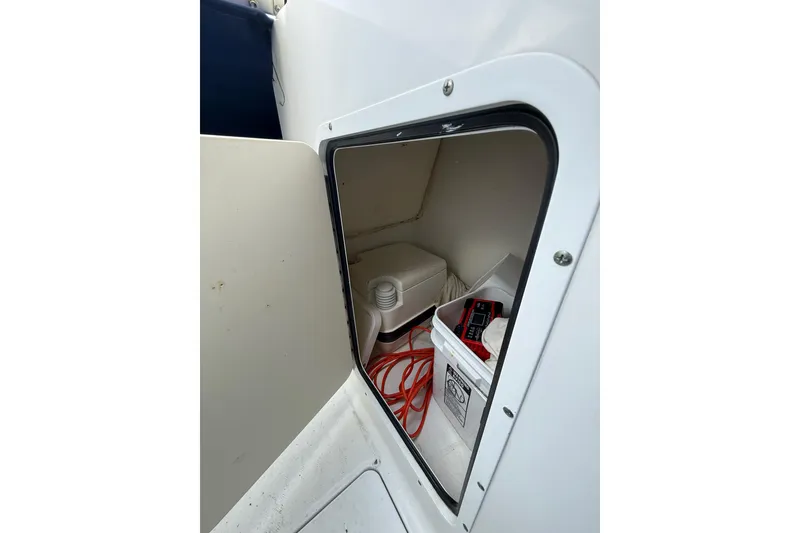 Slide: The Image of Storage compartment on a 2011 Sea Hunt Escape 220 LE boat with equipment inside. - 18
