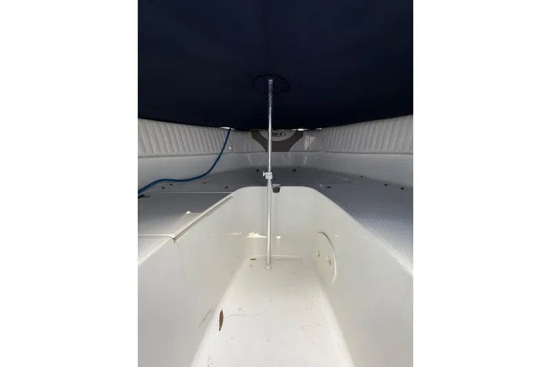 Slide: The Image of 2011 Sea Hunt Escape 220 LE boat interior with canopy and seating area. - 19