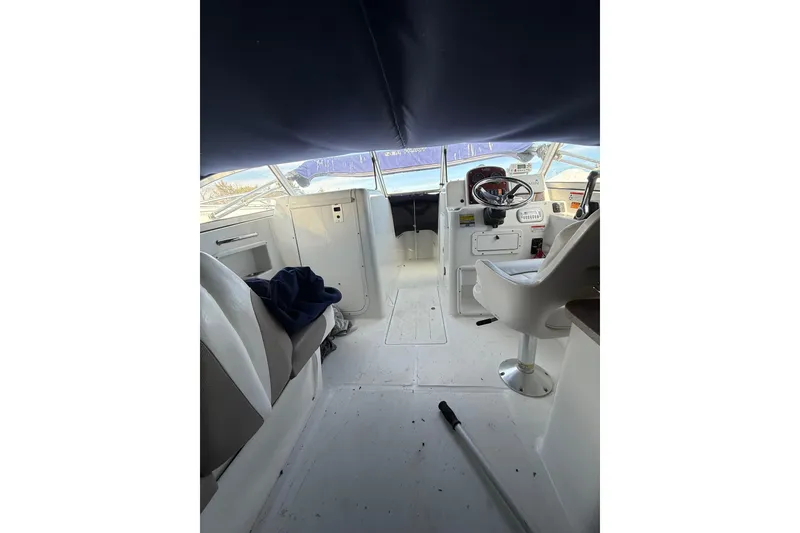 Slide: The Image of Interior view of 2011 Sea Hunt Escape 220 LE boat cockpit with seating and steering wheel. - 22