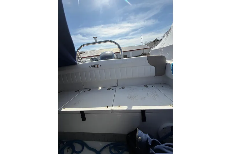 Slide: The Image of 2011 Sea Hunt Escape 220 LE boat interior with seating and storage compartments. - 23