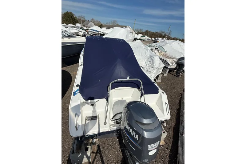 Slide: The Image of 2011 Sea Hunt Escape 220 LE boat with Yamaha 150 engine, covered and stored outdoors. - 28