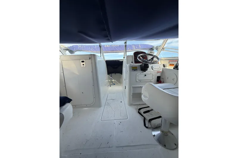 Slide: The Image of 2011 Sea Hunt Escape 220 LE boat interior with steering wheel and seating. - 8