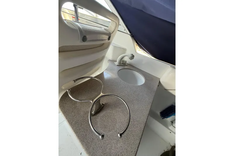 Slide: The Image of Interior of 2011 Sea Hunt Escape 220 LE boat with sink and cup holders. - 9